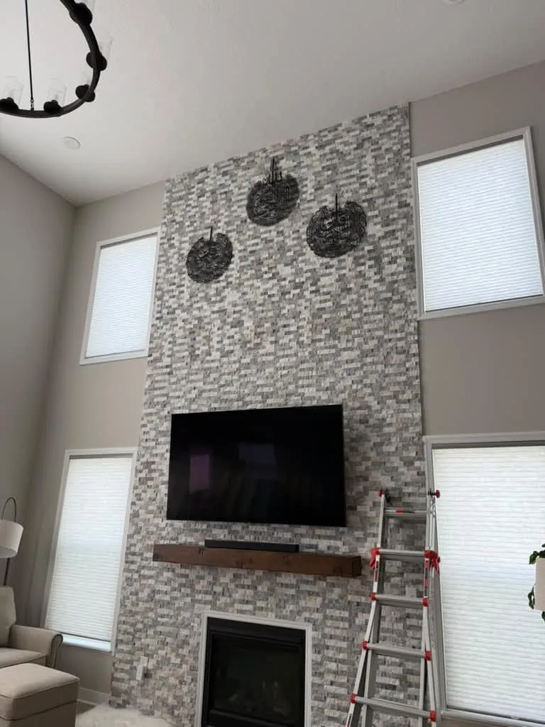 Living room with a finished stone fireplace wall
