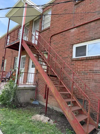 Rusted exterior metal staircase before restoration